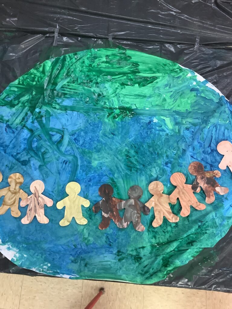 preschool art project: earth with human cutouts for Martin Luther King Jr. Day