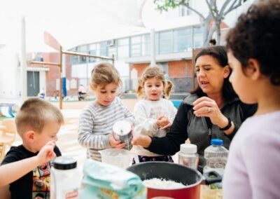 TEBH ECC preschool activity outdoors with students and teacher